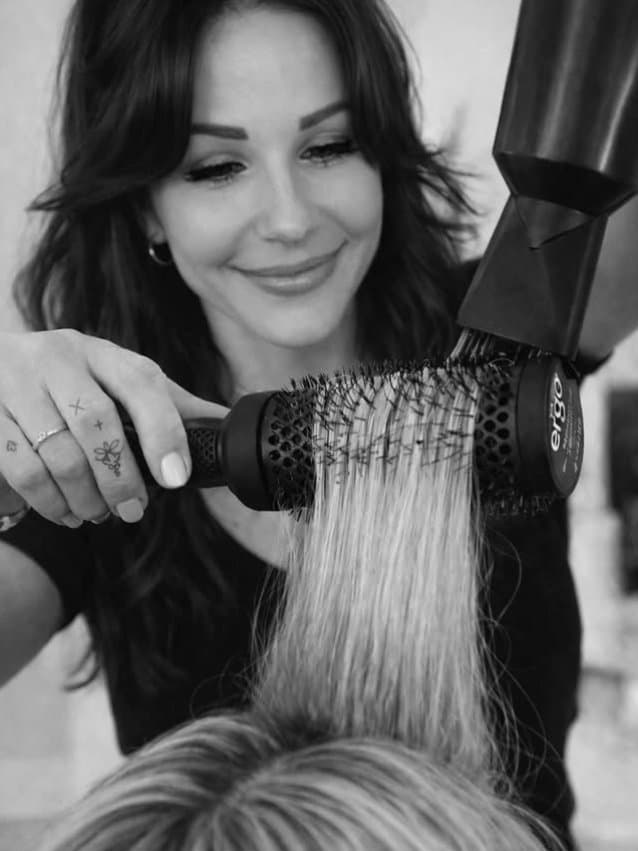 Heni styling a client — Hair by Heni Tampa.